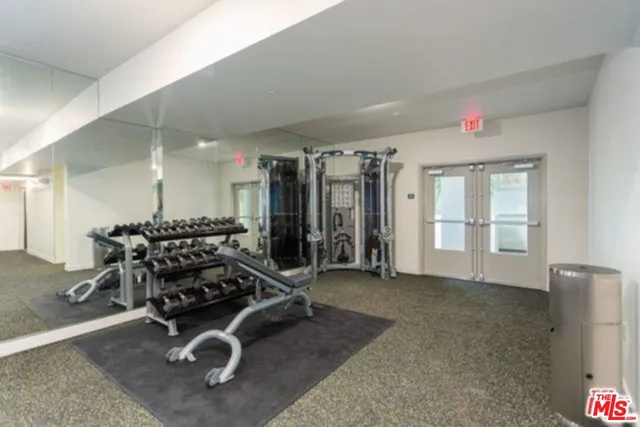 a room with gym equipment and windows