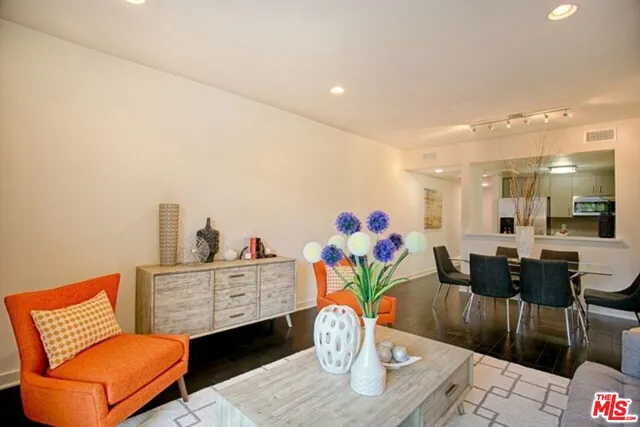 a living room with furniture and painting on the wall