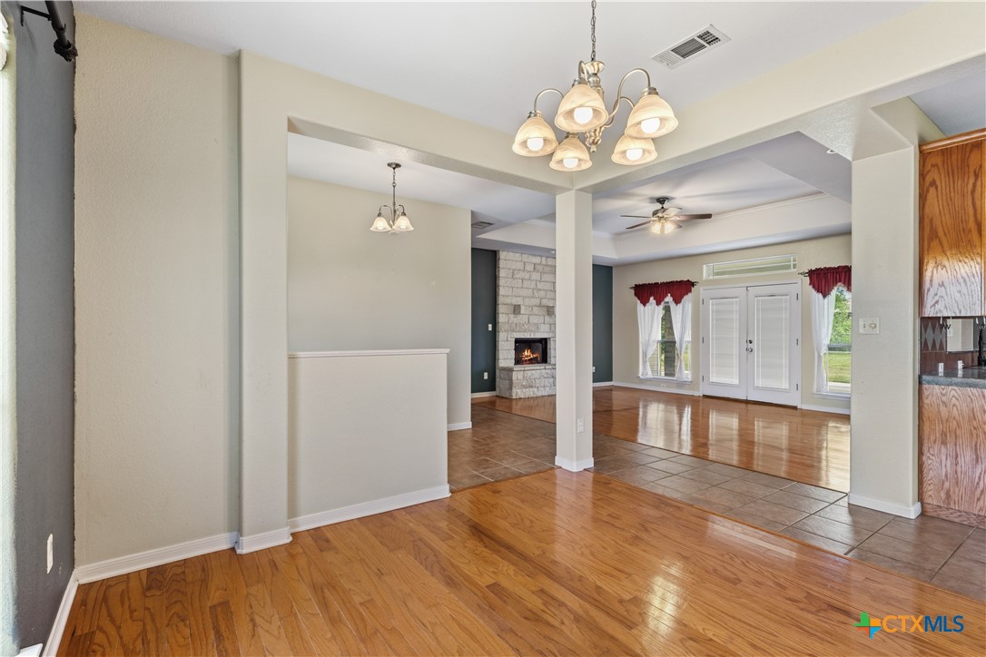 283 County Road 4710 Kempner, TX 76539 - Photo 12 of 47 a view of an empty room and kitchen with wooden floor