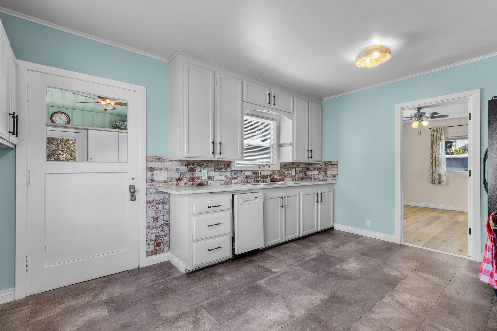 924 Northeast 9th Street Bend, OR 97701 - Photo 12 of 40 a kitchen with granite countertop white cabinets and white appliances