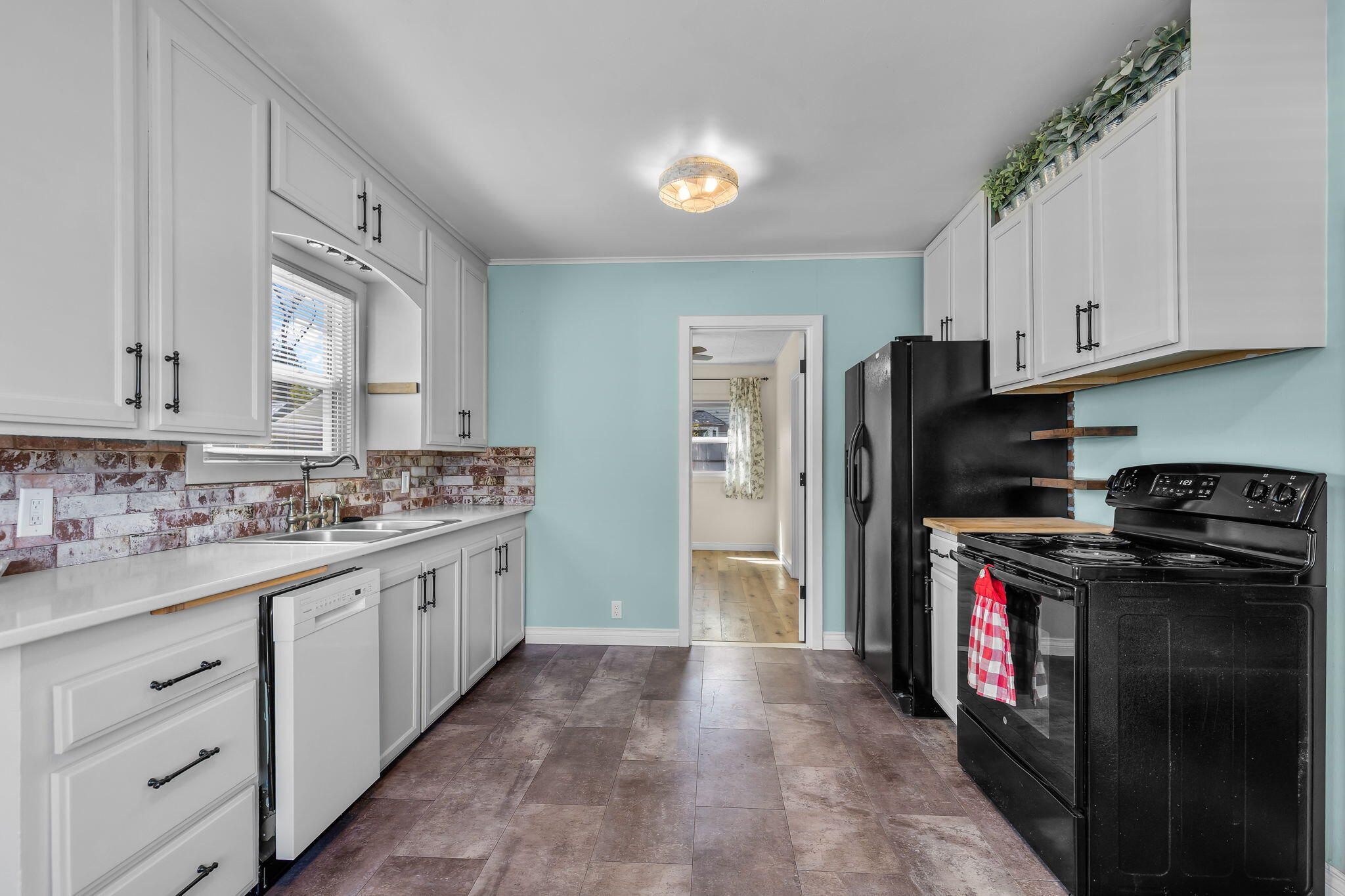 924 Northeast 9th Street Bend, OR 97701 - Photo 13 of 40 a kitchen with a stove top oven sink and refrigerator