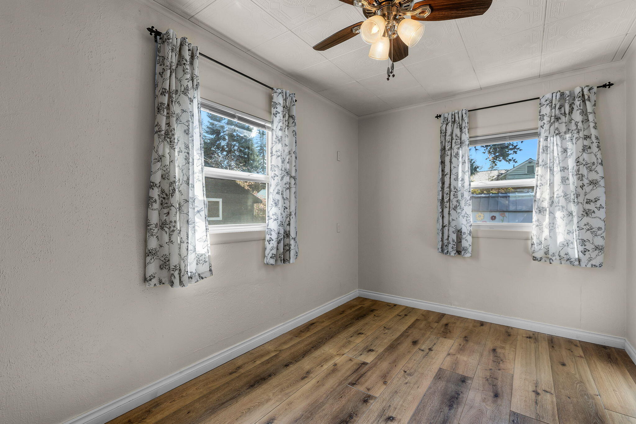 924 Northeast 9th Street Bend, OR 97701 - Photo 16 of 40 a view of empty room with wooden floor and fan