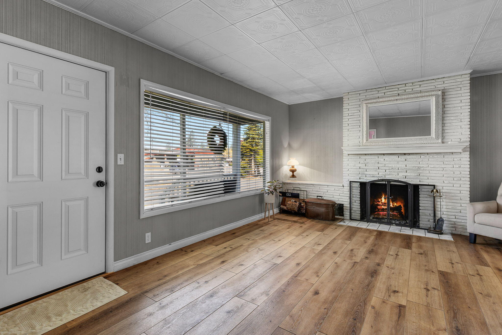 924 Northeast 9th Street Bend, OR 97701 - Photo 8 of 40 a view of a livingroom with a fireplace window and wooden floor