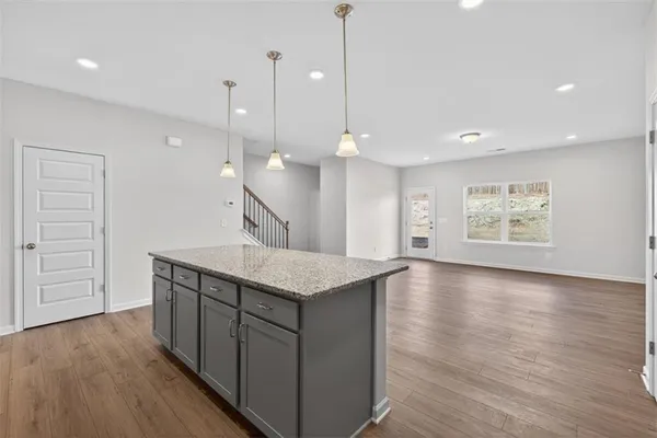 a kitchen with a wooden floor and window