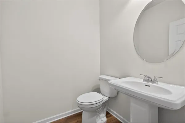 a bathroom with a sink toilet and a mirror
