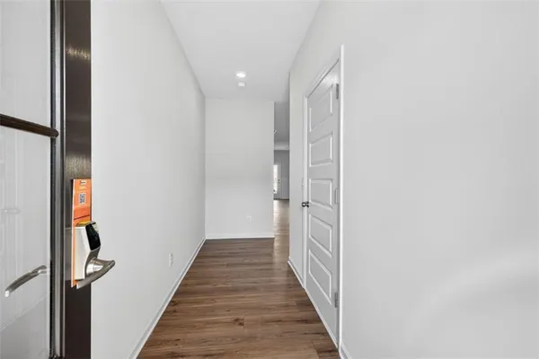 a view of hallway with wooden floor