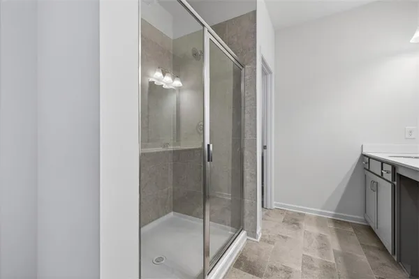 a bathroom with a glass shower door