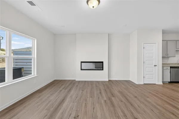a view of a room with wooden floor and window