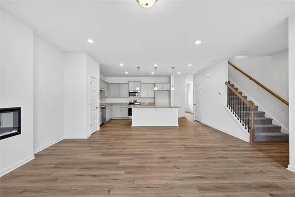 a view of kitchen dining room with wooden floor and kitchen