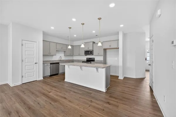 a large kitchen with a lot of counter space and stainless steel appliances