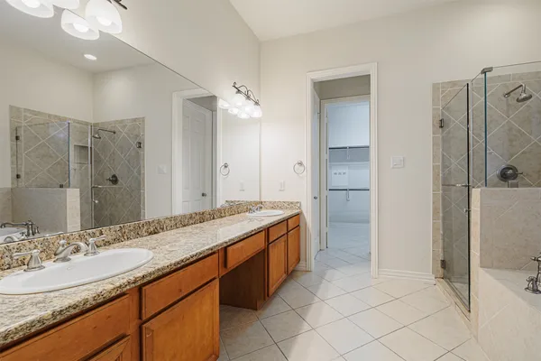 a bathroom with a granite countertop toilet and a sink