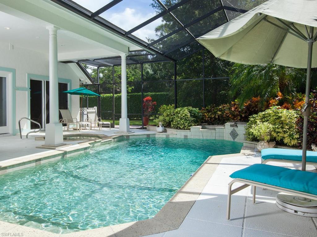 720 Turkey Oak Lane Naples, FL 34108 - Photo 14 of 17 a view of a chair and table in patio with a backyard