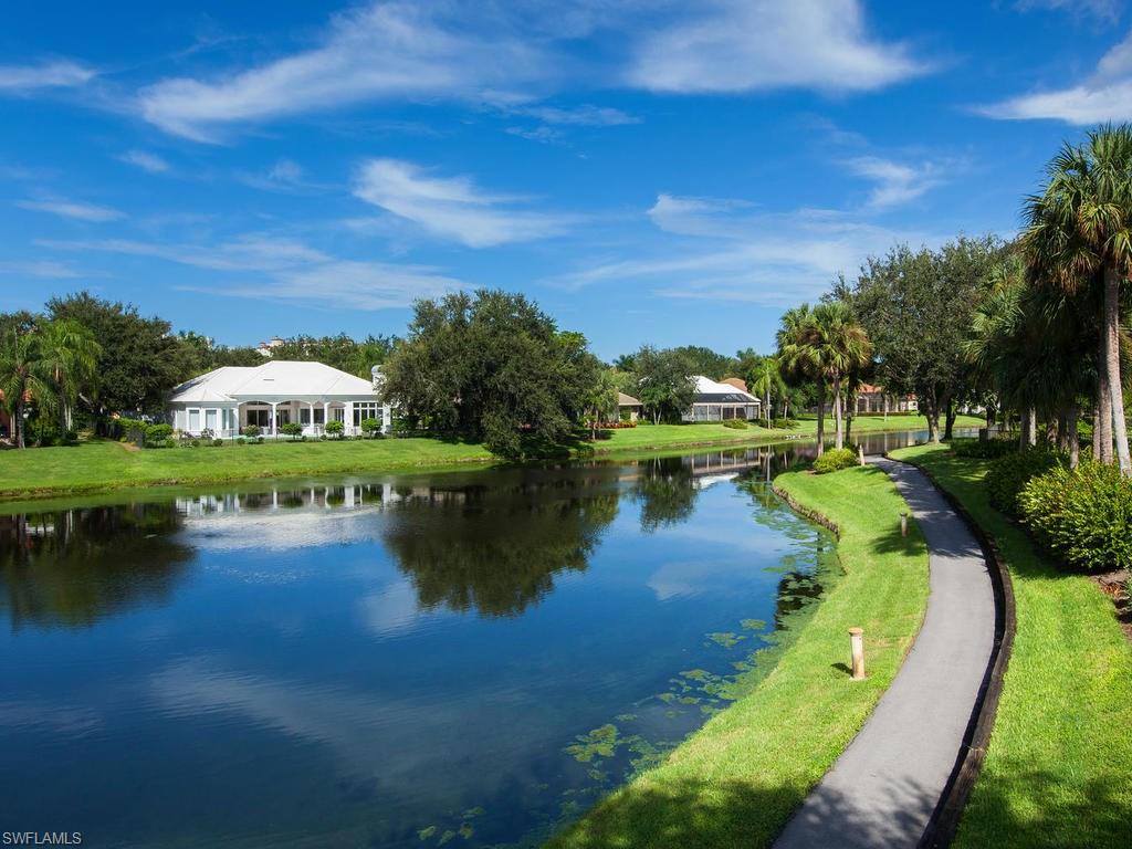 720 Turkey Oak Lane Naples, FL 34108 - Photo 17 of 17 a view of a lake with houses in the back