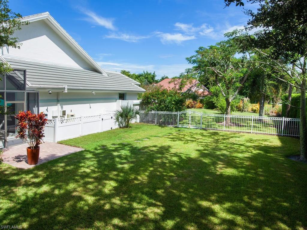 720 Turkey Oak Lane Naples, FL 34108 - Photo 3 of 17 a front view of a house with a yard