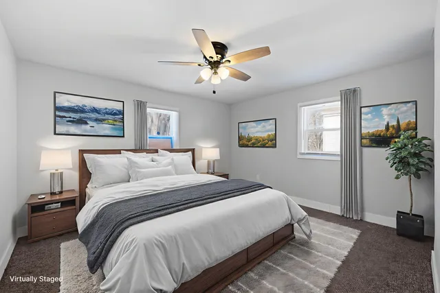 a bedroom with a bed and a potted plant