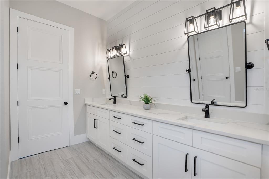 440 Palma Ceia Road Winter Haven, FL 33884 - Photo 35 of 78 a bathroom with a double vanity sink and mirror