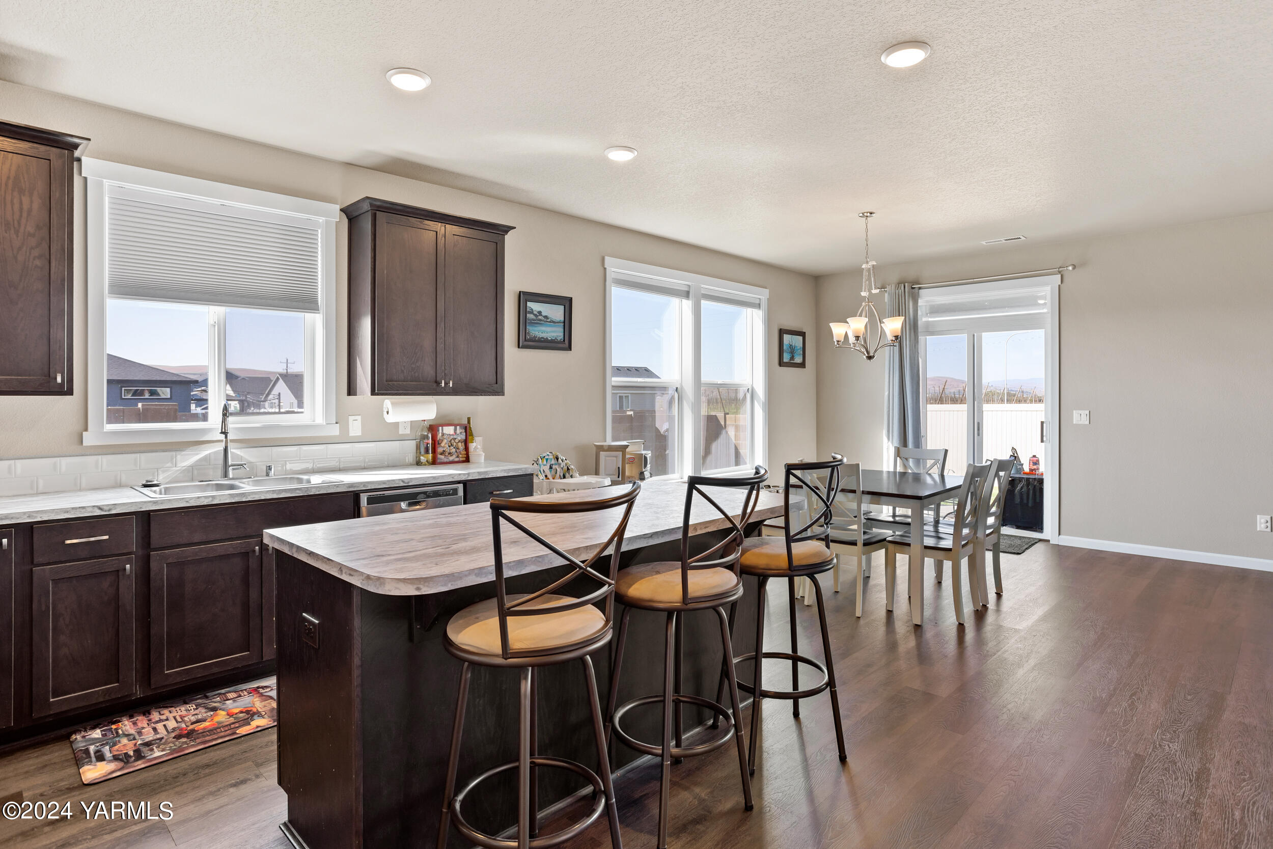 2100 Amber Loop Yakima, WA 98901 - Photo 7 of 25 a view of a dining room with furniture and wooden floor