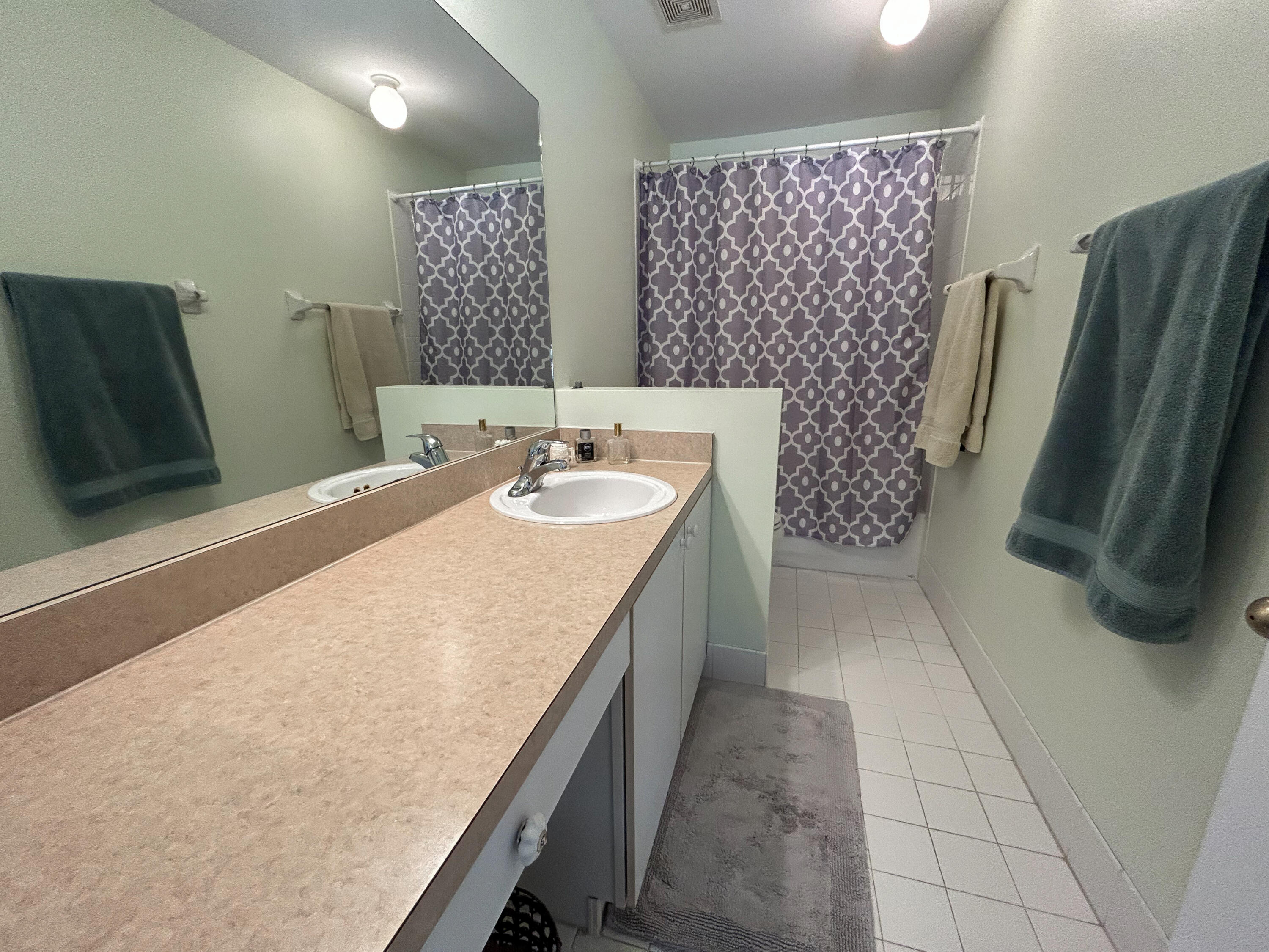 334 Timberwalk Trail Jupiter, FL 33458 - Photo 21 of 51 a bathroom with a granite countertop sink a mirror and a shower