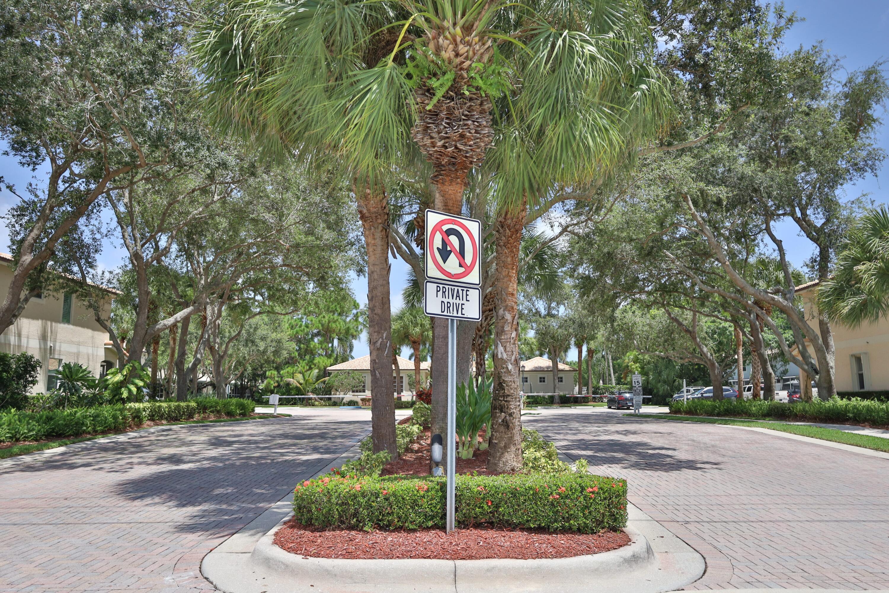 334 Timberwalk Trail Jupiter, FL 33458 - Photo 38 of 51 a street sign on a sidewalk next to road