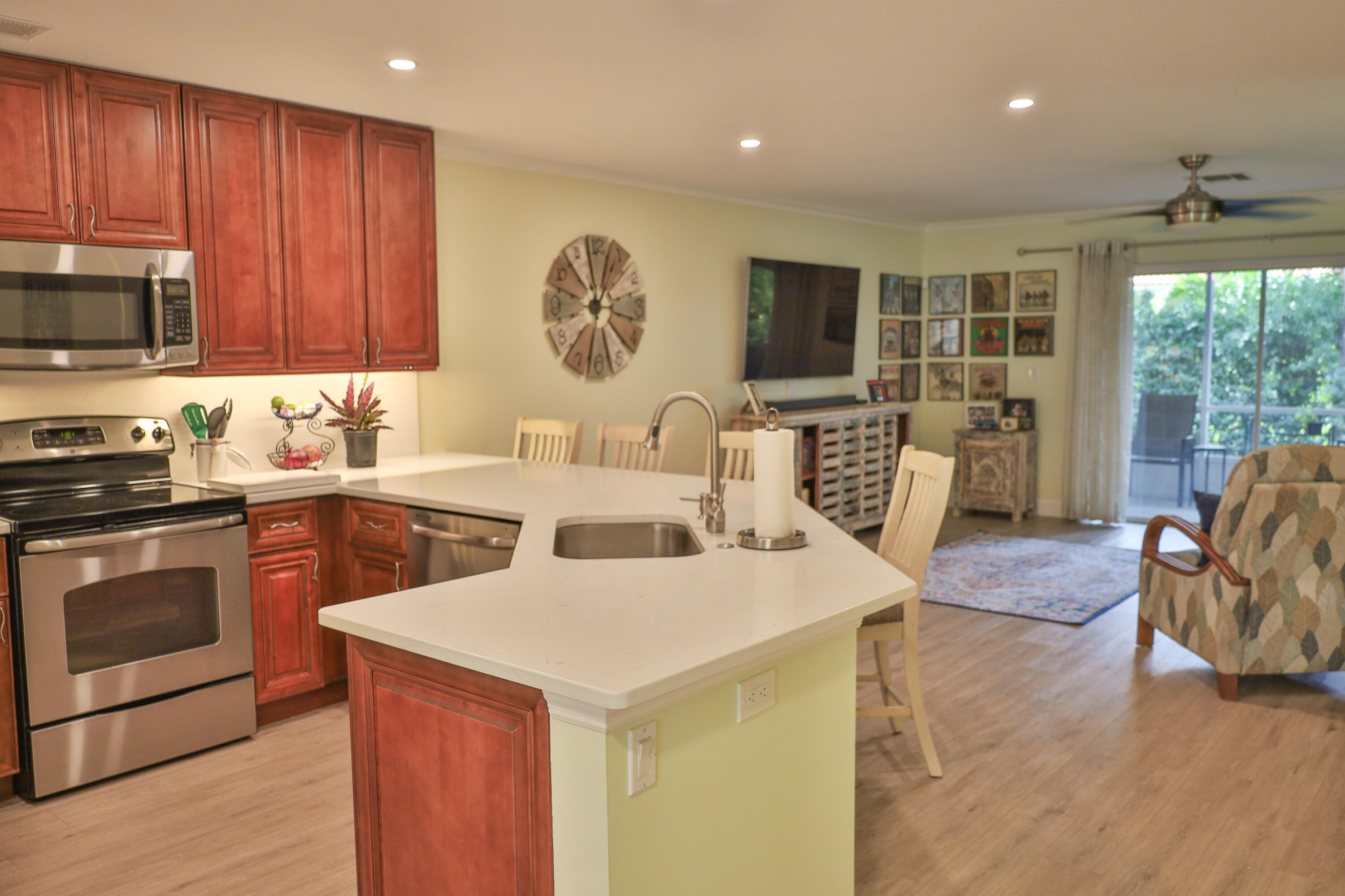 334 Timberwalk Trail Jupiter, FL 33458 - Photo 9 of 51 a view of kitchen with stainless steel appliances granite countertop a stove top oven a sink dishwasher a dining table and chairs with wooden floor