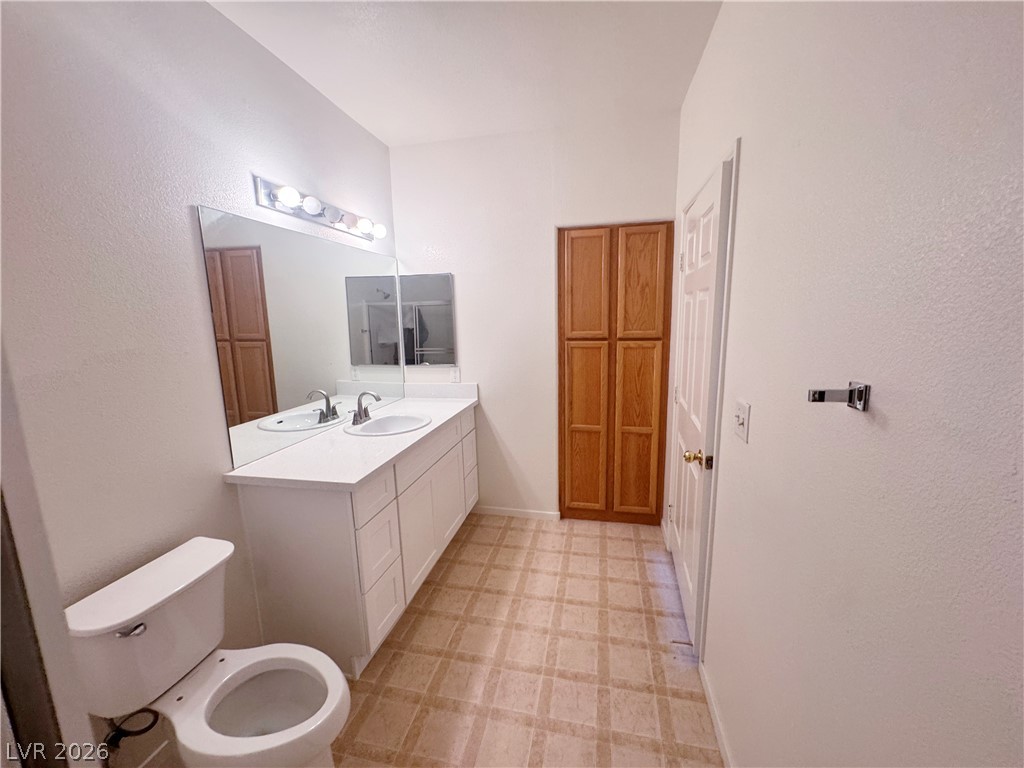 9580 West Reno Avenue, Unit 242 Las Vegas, NV 89148 - Photo 12 of 26 Dual vanity sinks provide ample space in this well-appointed bathroom.