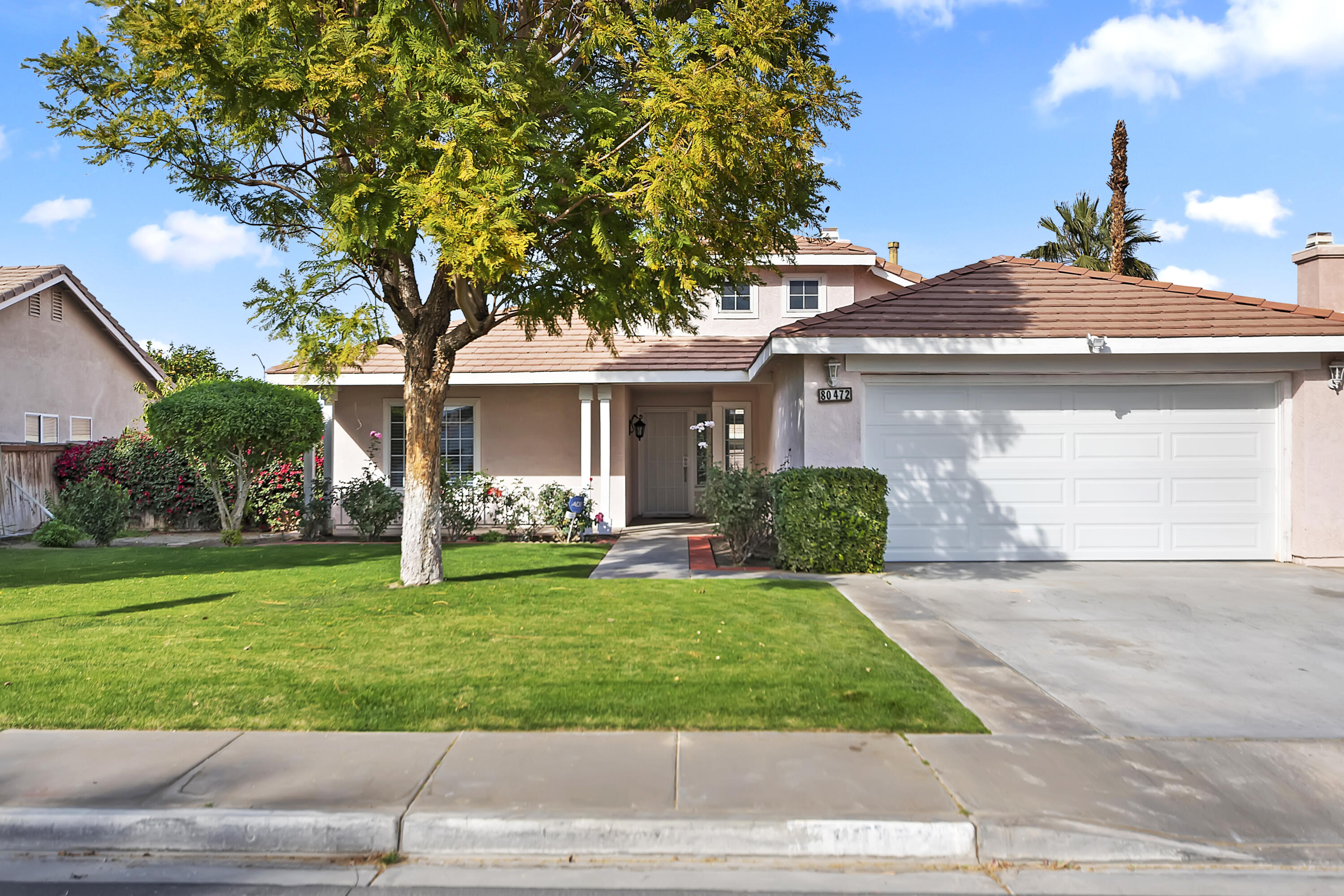 a front view of a house with a yard
