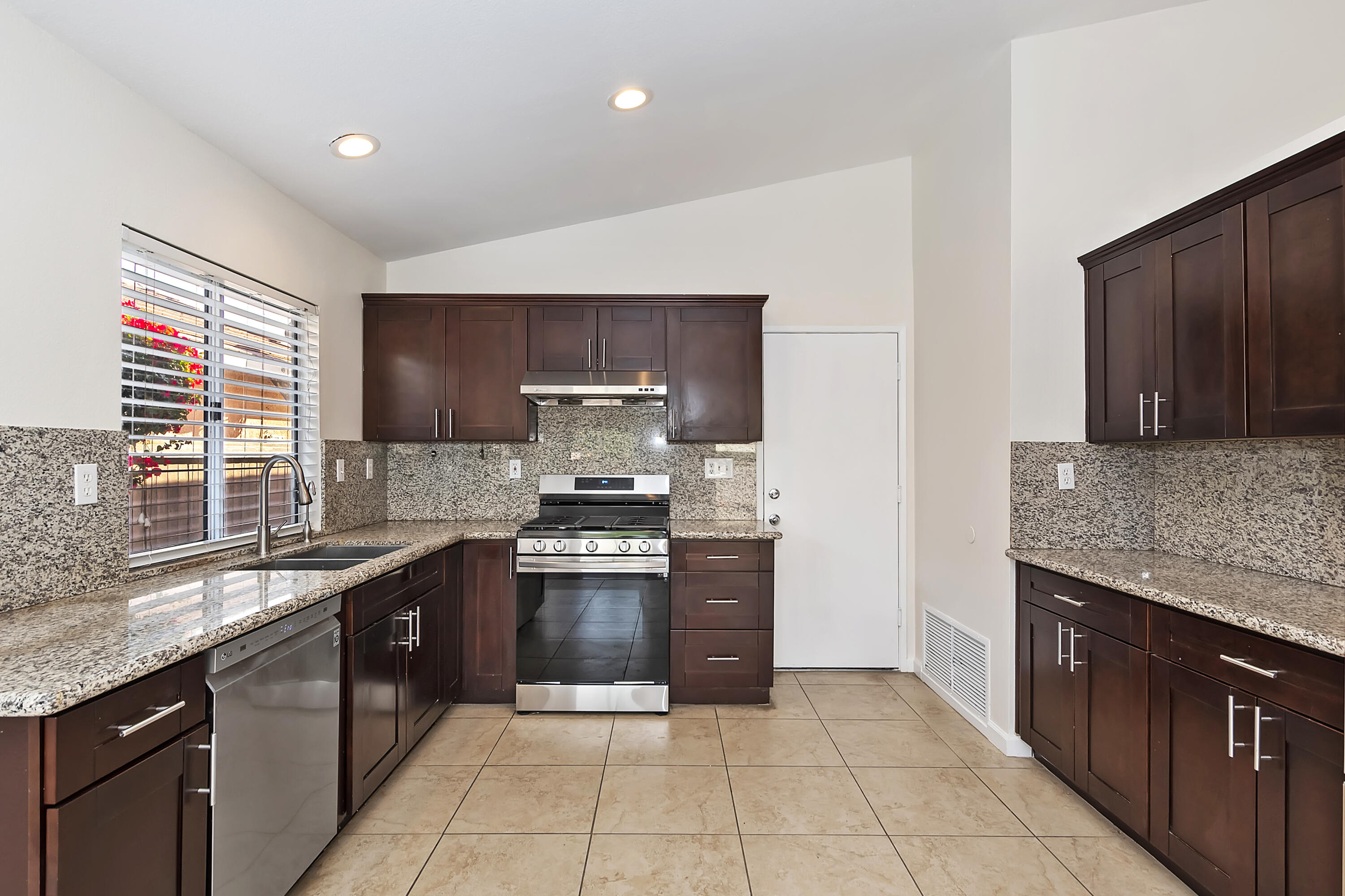 80472 Suncastle Road Indio, CA 92201 - Photo 14 of 32 a kitchen with stainless steel appliances granite countertop a stove sink and cabinets