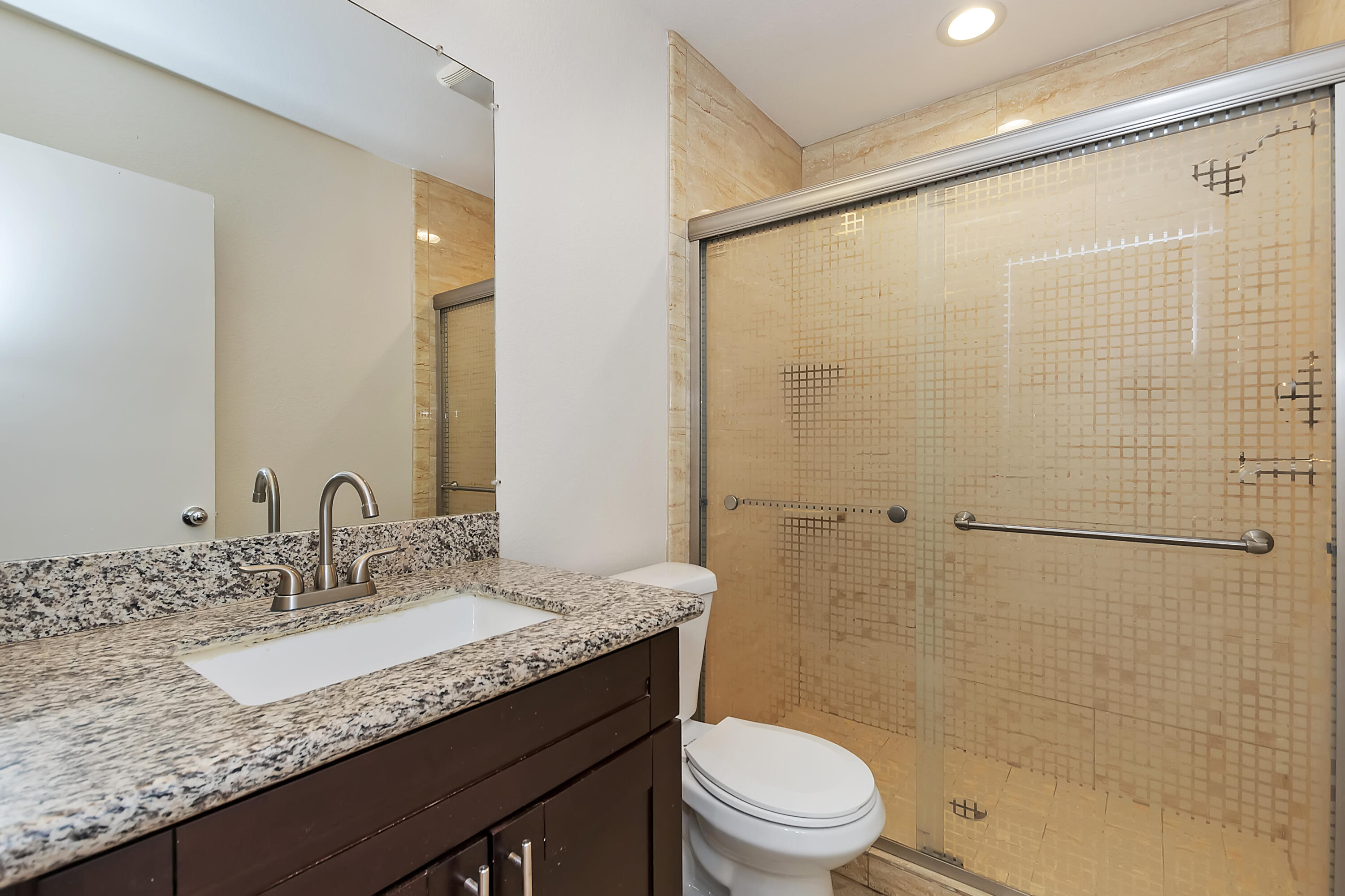 80472 Suncastle Road Indio, CA 92201 - Photo 19 of 32 a bathroom with a granite countertop sink toilet and shower