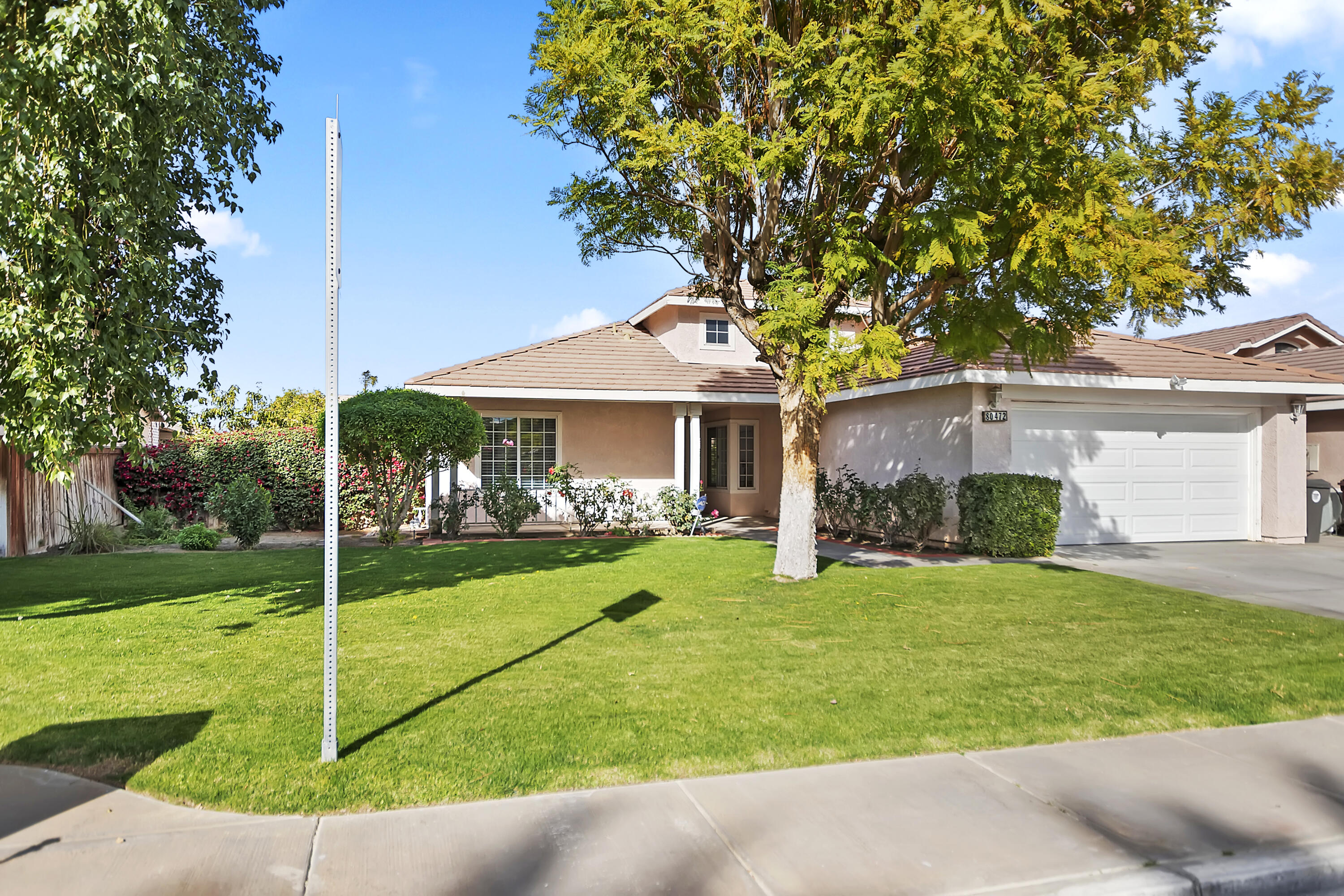 80472 Suncastle Road Indio, CA 92201 - Photo 3 of 32 a view of a house with a yard and tree s