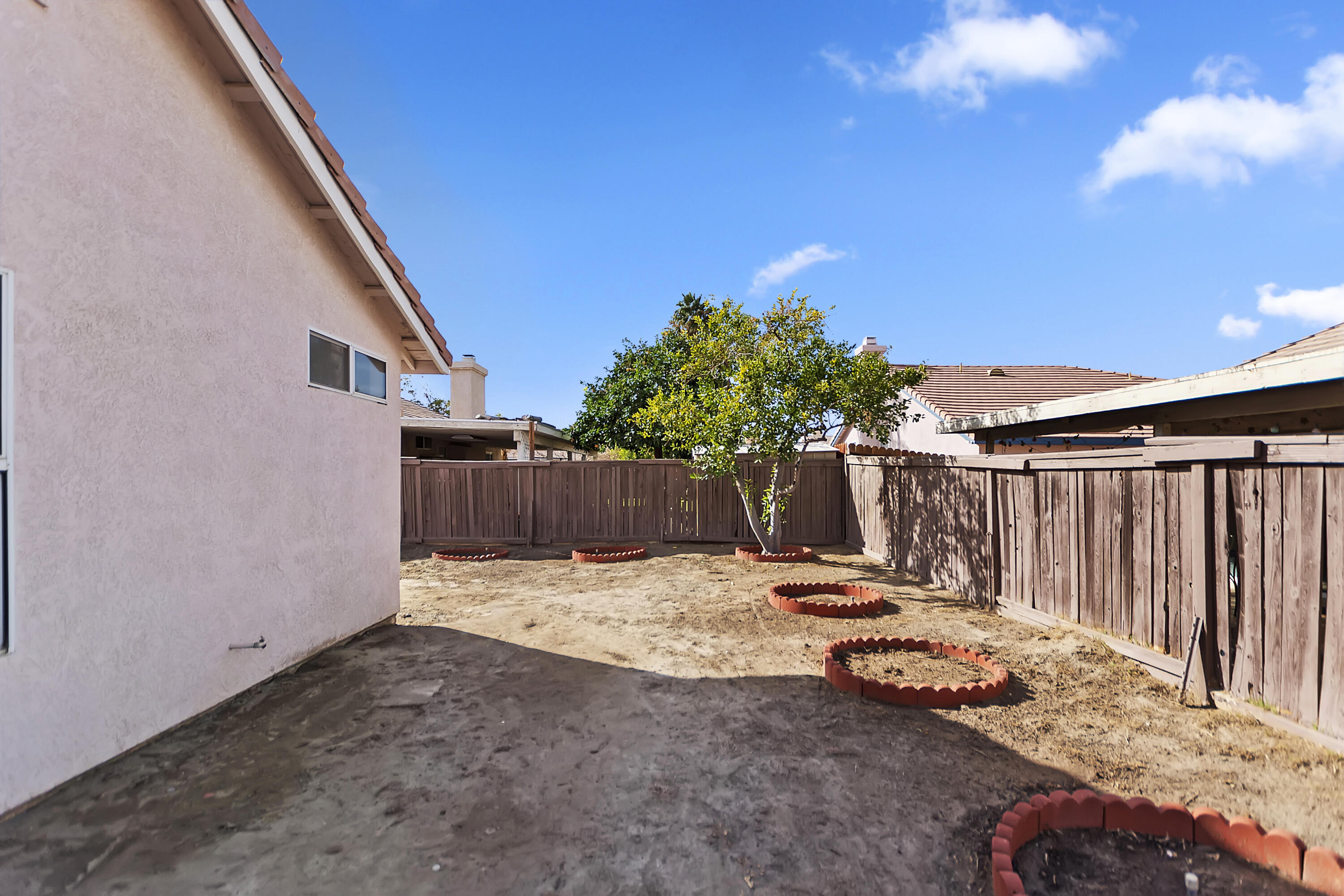 80472 Suncastle Road Indio, CA 92201 - Photo 31 of 32 a view of a backyard with wooden fence
