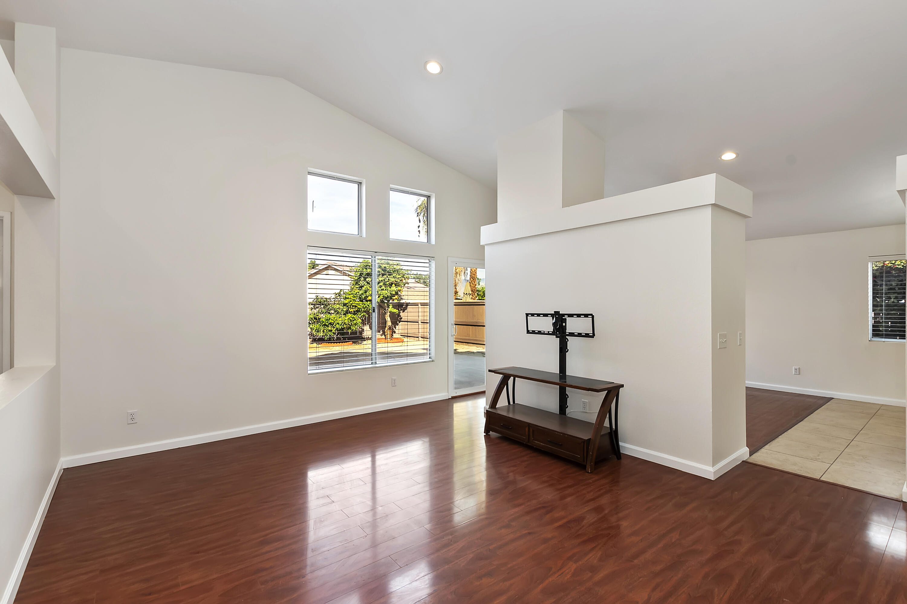 80472 Suncastle Road Indio, CA 92201 - Photo 4 of 32 a view of a room with wooden floor a ceiling fan and windows