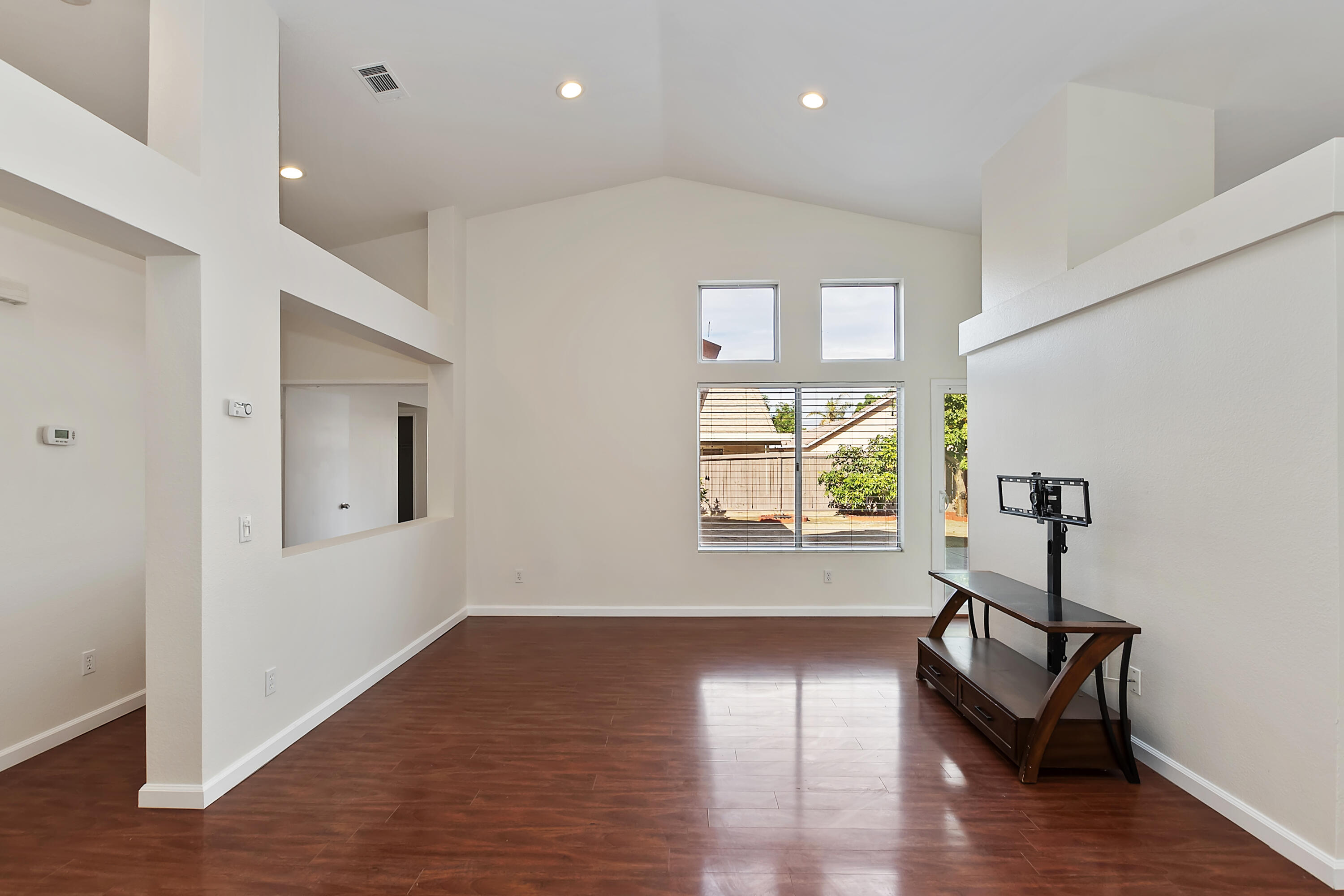 80472 Suncastle Road Indio, CA 92201 - Photo 5 of 32 a view of an empty room with wooden floor and a window