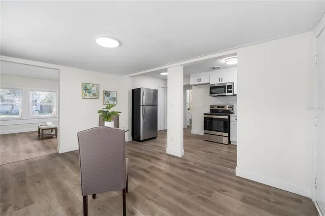 a living room with furniture and a kitchen view