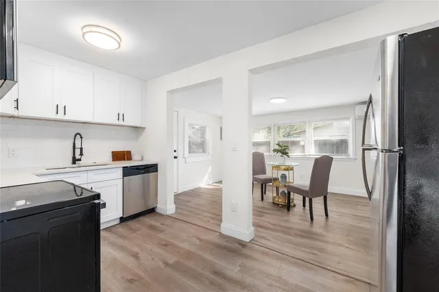 a view of kitchen with cabinets and wooden floor