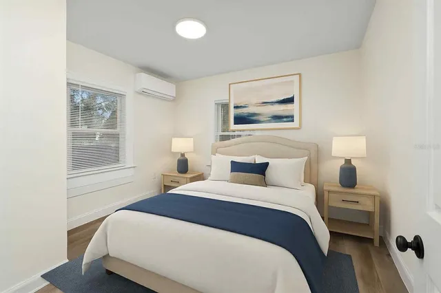 a bedroom with a bed and a lamp on dresser