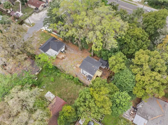 an aerial view of a house with yard and outdoor seating