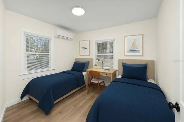 a bedroom with a bed and wooden floor