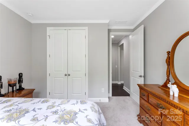 a bedroom with a bed and a mirror