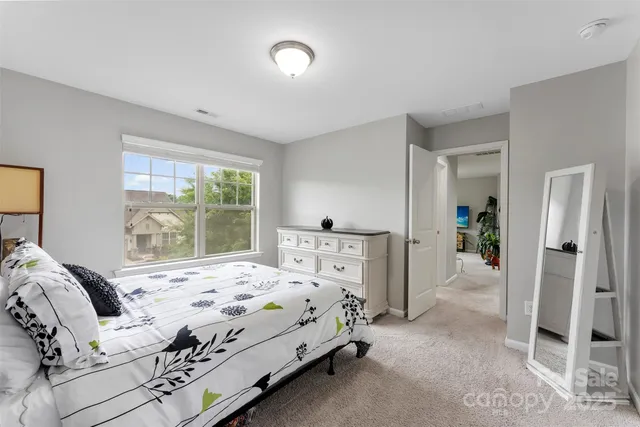 a bedroom with a bed and a large window