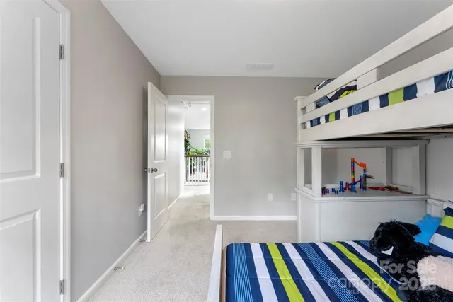 a bedroom with furniture and a book shelf