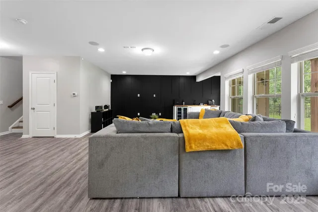 a living room with furniture and large windows