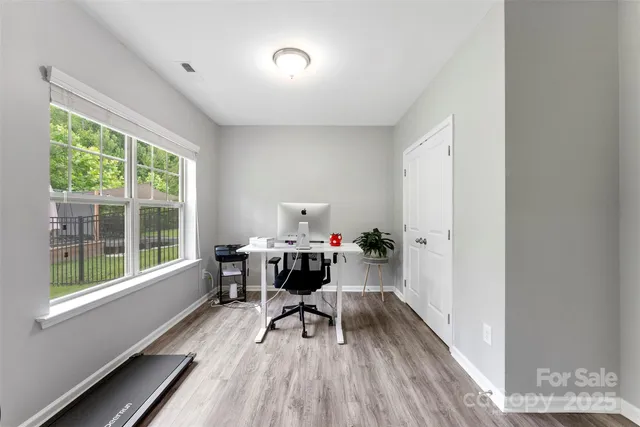 a view of a workspace with furniture and a window