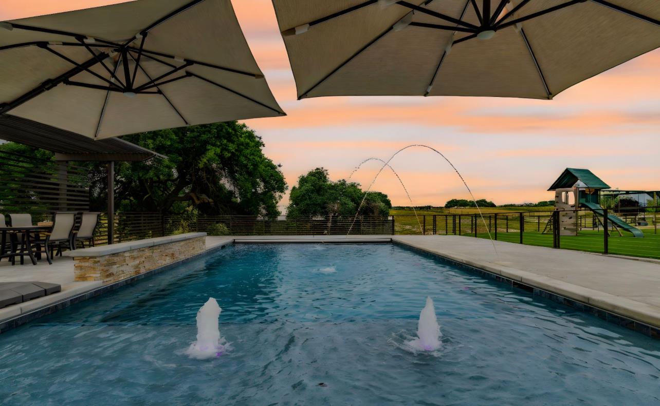 5600 Ferseyna Way Valley Springs, CA 95252 - Photo 21 of 94 a view of a terrace with a table and chairs under an umbrella