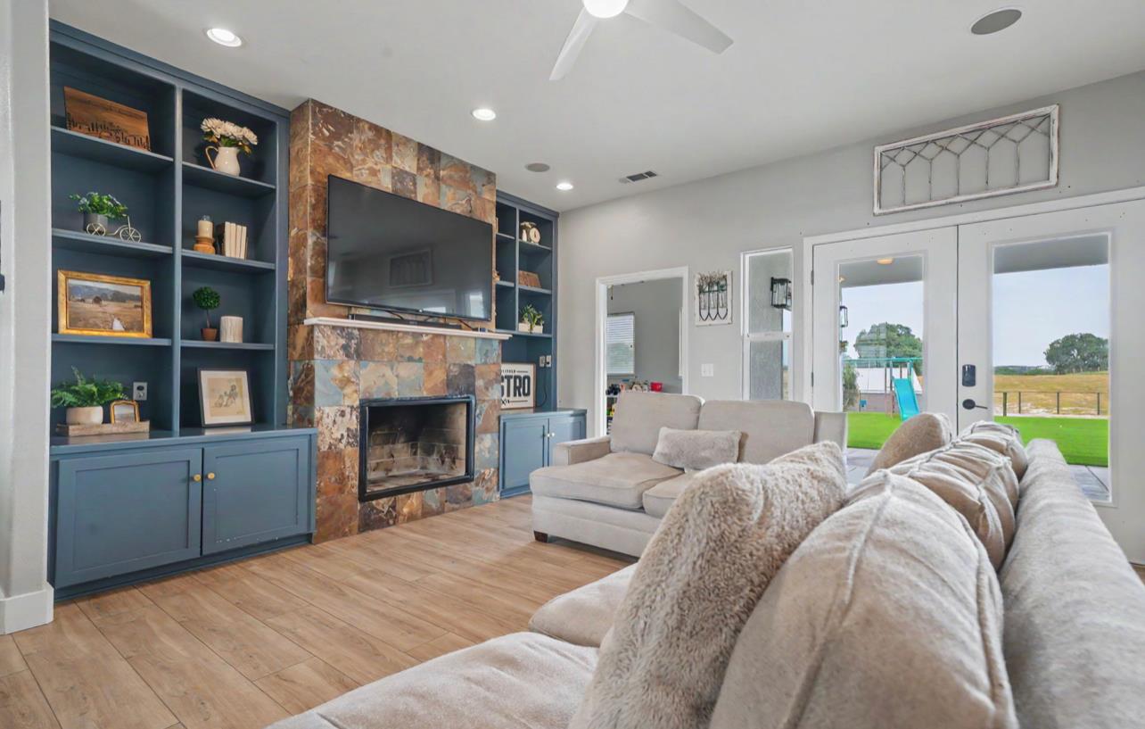 5600 Ferseyna Way Valley Springs, CA 95252 - Photo 52 of 94 a living room with furniture a fireplace and a flat screen tv