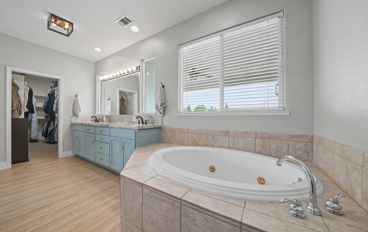 5600 Ferseyna Way Valley Springs, CA 95252 - Photo 69 of 94 a bathroom with a tub sink and mirror