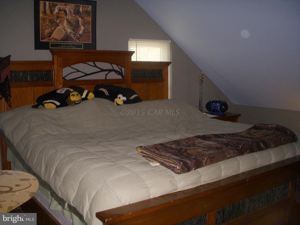 7674 Bethel Road Willards, MD 21874 - Photo 11 of 11 a bed sitting in a bedroom next to a window
