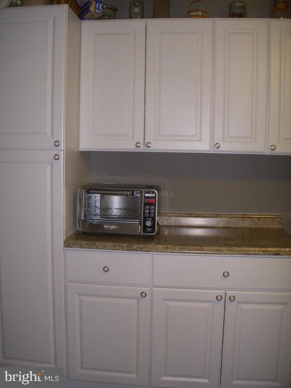 7674 Bethel Road Willards, MD 21874 - Photo 4 of 11 a kitchen with white cabinets and sink