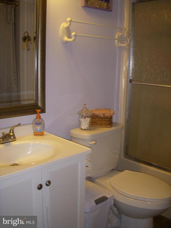 7674 Bethel Road Willards, MD 21874 - Photo 7 of 11 a bathroom with a sink a toilet and shower
