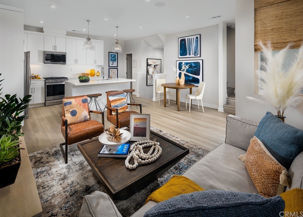 a living room with furniture kitchen view and a couch