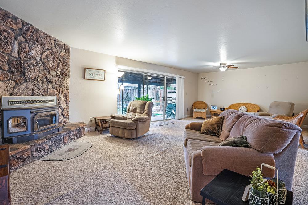 140 Rays Circle Hollister, CA 95023 - Photo 12 of 31 a living room with furniture a fireplace and a flat screen tv